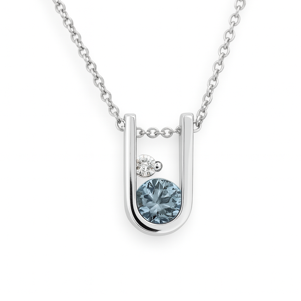 A white-gold U-pendant holding an aquamarine and a diamond.